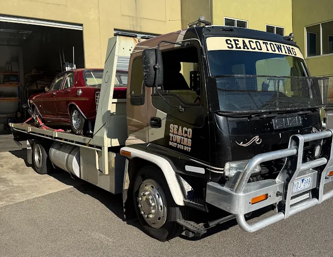 Seaco Towing tilt tray with a classic red Rover loaded in Geelong