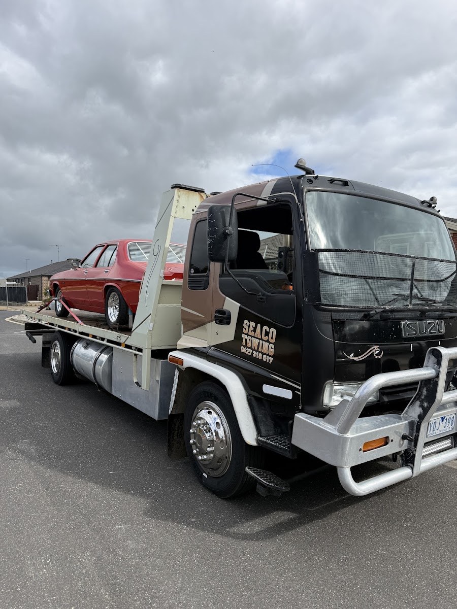 Seaco Towing Isuzu tilt tray with a classic Holden secured on the tray